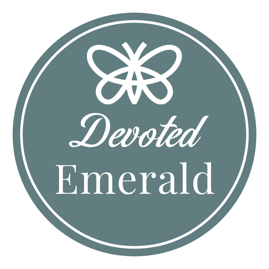 Emerald A circular taupe logo features a white butterfly icon above the words "Devoted Emerald" in script and serif fonts.