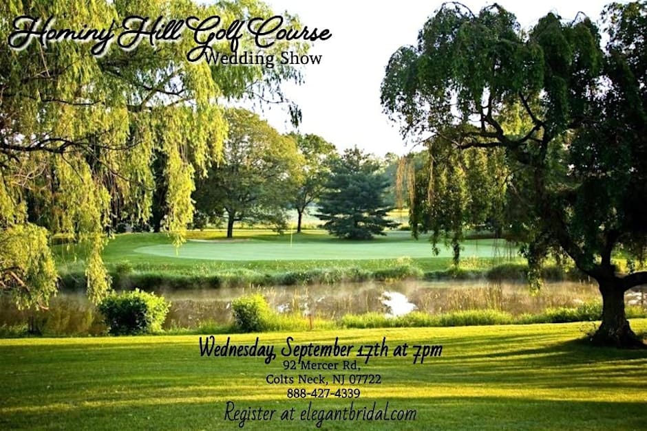Scenic view of Hominy Hill Golf Course with lush green trees, a pond, and rolling fairways on a sunny day.