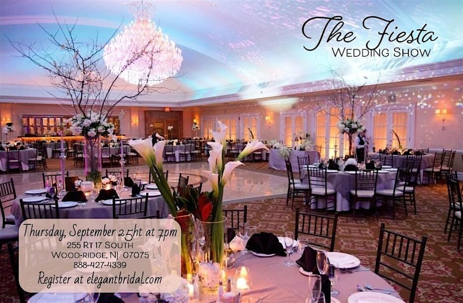 Elegant ballroom at The Fiesta in Wood-Ridge, NJ, decorated with tall floral centerpieces, candlelight, and a sparkling chandelier for a wedding show.