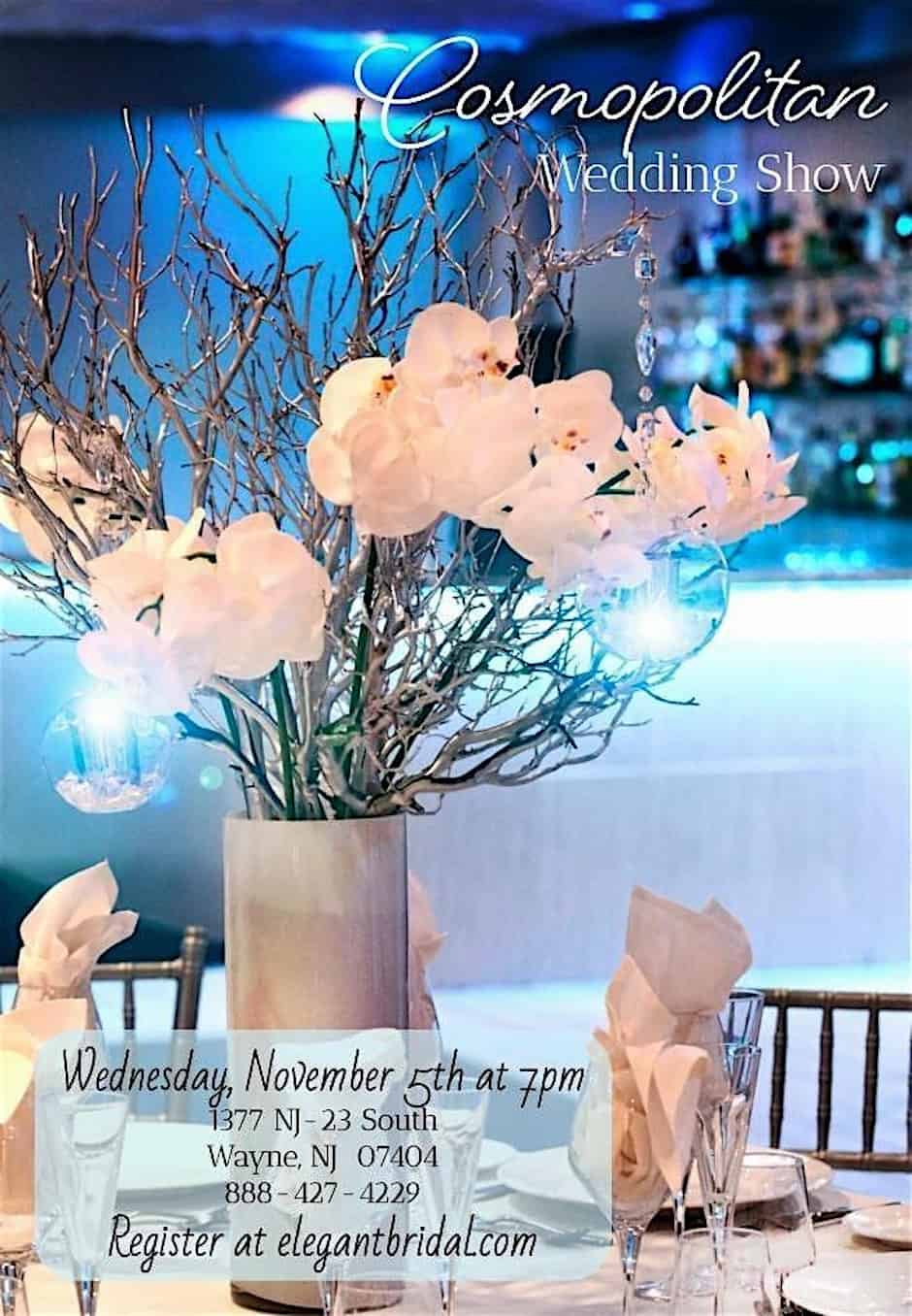 Elegant wedding table centerpiece with white orchids, crystal accents, and soft blue lighting at the Cosmopolitan in Wayne NJ.