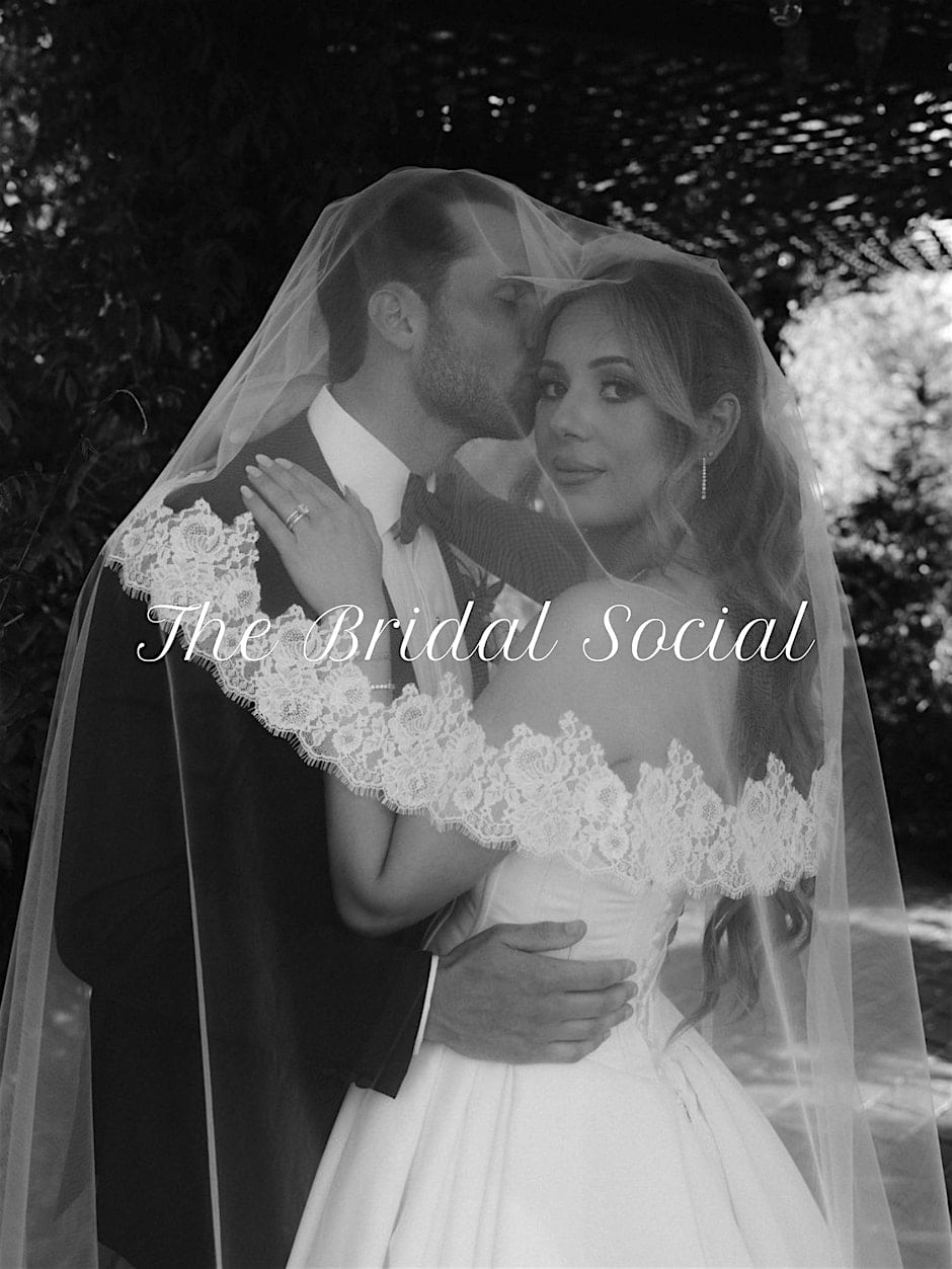 Black and white photo of a bride and groom embracing under a veil, with the words “The Bridal Social” overlaid.