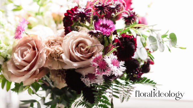 Wedding bouquet with blush roses, burgundy blooms, and textured greenery by Floral Ideology in Wayne, New Jersey